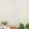 White wooden floral panel wall decor with cutout metal backing and beaded frame.
